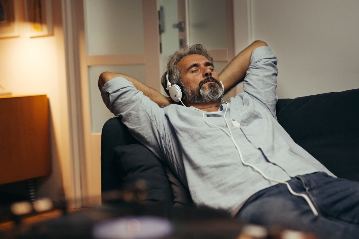 man laying down listening to music