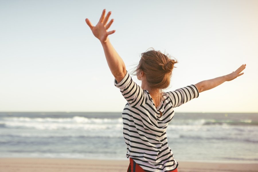 woman hands free on beach