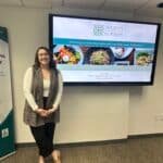Stephanie Walker presenting a nutrition and wellness talk at VRS with a slideshow projected behind her.